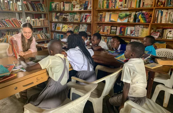 A young woman reading to a group of students