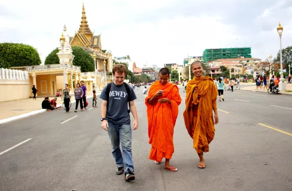 A young man walking with two Buddhist monks