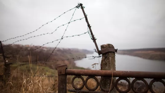 A barbed wire fence near a river