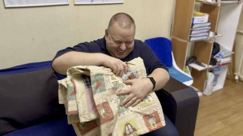 Serhiy,* who is blind,  examines the new MCC comforter he just received from MCC partner New Life in Nikopol, Ukraine.

*Family name is withheld for security reasons.